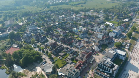 Aerial-drone-flying-above-city-of-Scharbeutz-in-Germany,-circle-pan,-day